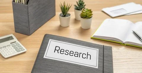 A folder on a desk with the label Research Photos