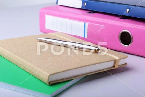 Folder file, note and pen on the desk. blurred background. Stock Photo ...