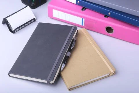 Folder file, note and pen on the desk. blurred background. Stock Photos