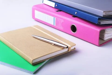 Folder file, note and pen on the desk. blurred background. Stock Photos