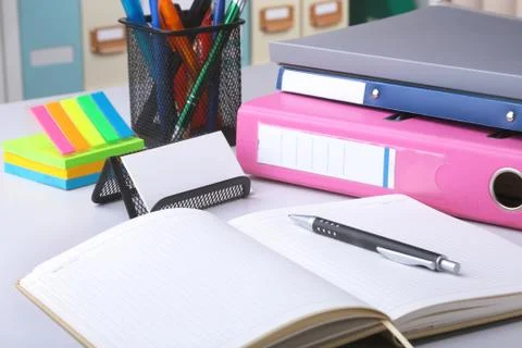 Folder file, note and pen on the desk. blurred background. Stock Photos