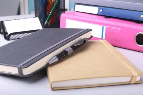 Folder file, note and pen on the desk. blurred background. Stock Photos