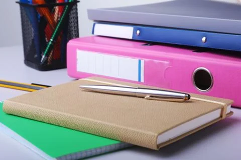 Folder file, note and pen on the desk. blurred background. Stock Photos