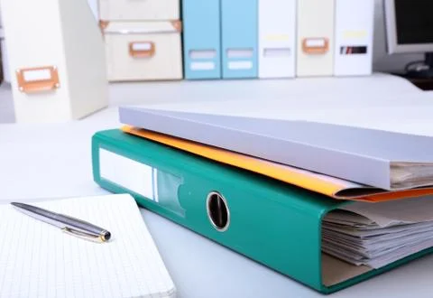 Folder file, note and pen on the desk. blurred background. Stock Photos
