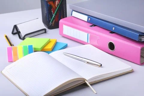 Folder file, note, pen and watch on the desk. blurred background. Stock Photos
