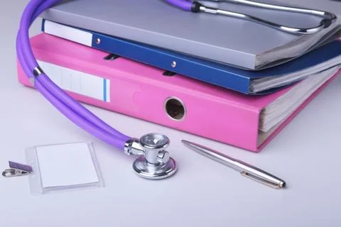 Folder file, stethoscope and RX prescription on the desk. blurred background. Stock Photos