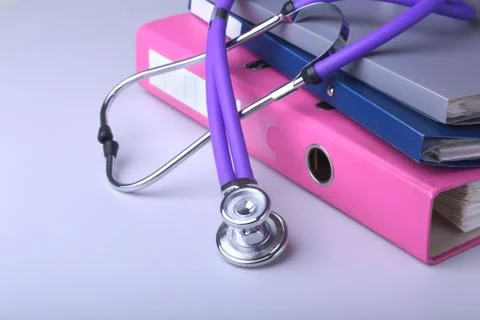 Folder file, stethoscope and RX prescription on the desk. blurred background. Stock Photos