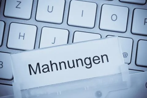 A folder for files in a hanging file in front of a computer keyboard on the 库存照片
