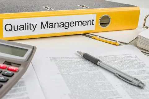 Folder with the label quality management Stock Photos