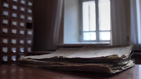 Folder with old documents lies on a table in an archive or file cabinet building Stock Footage 229721087
