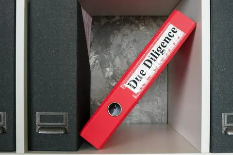 Folder on a shelf with a Due Diligence label. Stock Photos