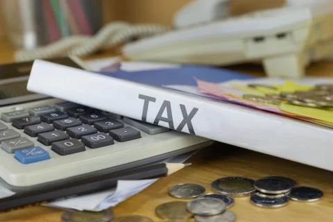 Folder Tax documents and paper files with coin calculator concept Annual tax Stock Photos