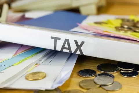 Folder Tax documents and paper files with coin  concept Annual tax payment Stock Photos