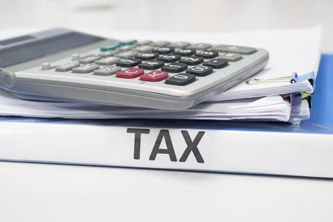 Folder Tax documents and paper files with calculator Photos