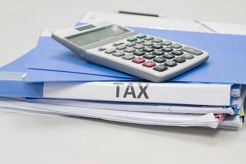 Folder Tax documents and paper files with calculator concept Annual tax payme Fotos Stock