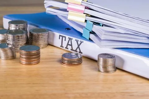 Folder Tax documents and stack of coin, concept Annual tax payment at work .. Fotos Stock