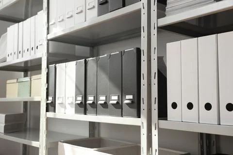 Folders and boxes with documents on shelves in archive Stockfoto's