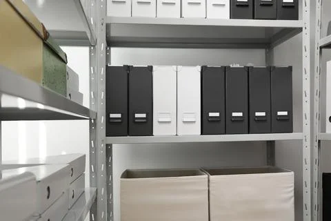 Folders and boxes with documents on shelves in archive Stockfoto's