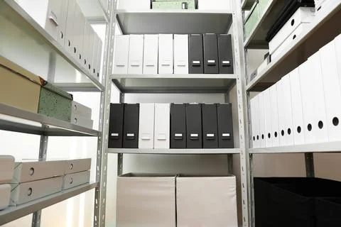 Folders and boxes with documents on shelves in archive Stockfoto's