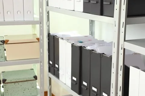 Folders and boxes with documents on shelves in archive Stockfoto's
