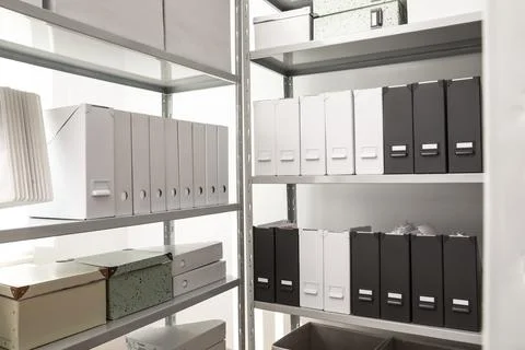 Folders and boxes with documents on shelves in archive Stockfoto's