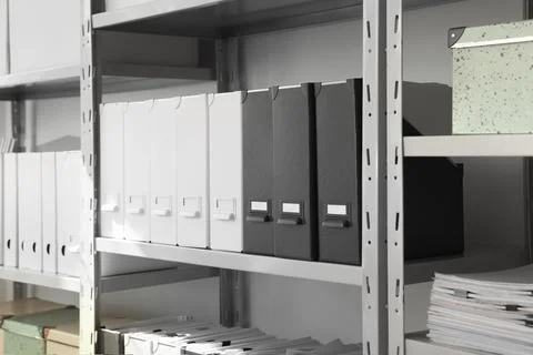 Folders and boxes with documents on shelves in archive Stockfoto's