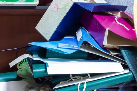 Folders binder with documents in a mess lie on the shelf Stock Photos