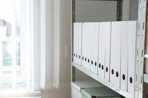 Folders with documents on shelf in archive. Space for text Stockfoto's