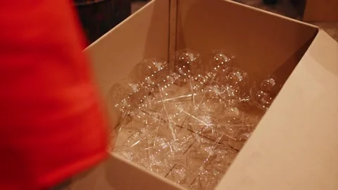 Folding blanks of Christmas tree decorations into a box by a factory employee. Video stock 222598685