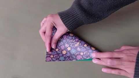 Folding the brown paper to make origami Stock Footage 150666409