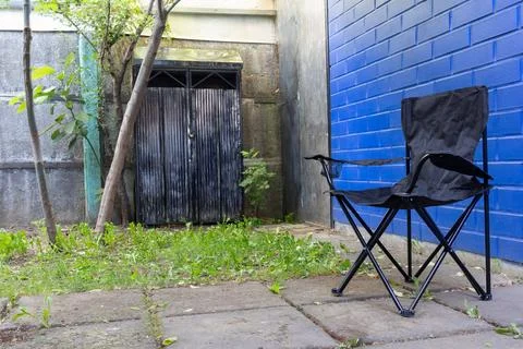 A folding chair in the backyard Stock Photos