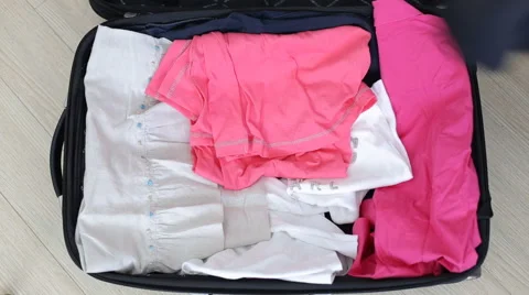 Folding clothes in travel bag Stock Footage 62204439