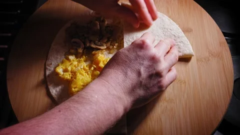 Folding Cut Tortilla Wrap With Scrambled Eggs, Mushroom And Onion, And Stock Footage 168159787