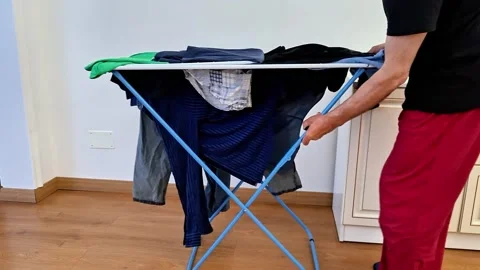 Folding Indoor Clothes Drying Rack After Laundry Use at Home Stock Footage 338317573