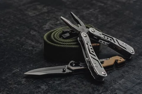 Folding knife with functional tool with tactical belt. Set of men's tools and Stock Photos