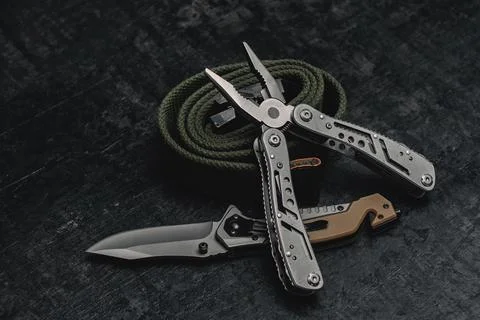Folding knife with functional tool with tactical belt. Set of men's tools and Stock Photos