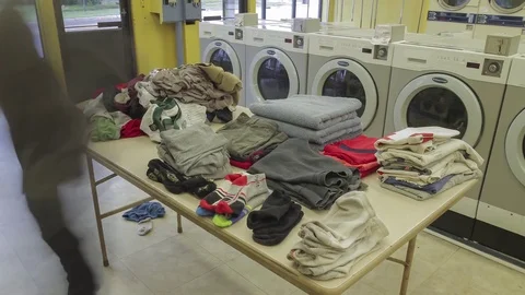 Folding Laundry at the Laundromat Video stock 81144029