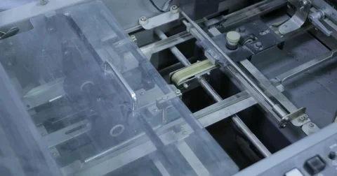 Folding machine folds printed offset sheet in print house Stock Footage 74902628