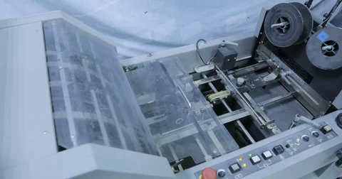 Folding machine folds printed offset sheet in print house Stock Footage 74903034