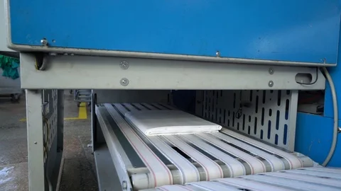 Folding machine at the laundry Stock Footage 119398138
