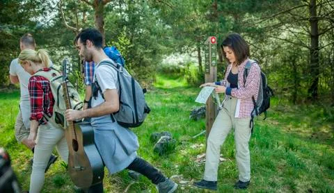 Folding the map and continuing their path Stock Photos