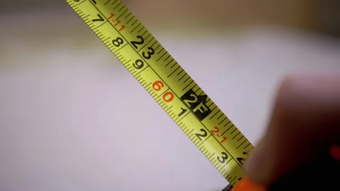 Folding a Measuring Inch Tape with a Double Scale of Numbers into a Tape Measure Vídeo Stock 164244949