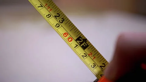 Folding a Measuring Inch Tape with a Double Scale of Numbers into a Tape Measure Vídeo Stock 166942926