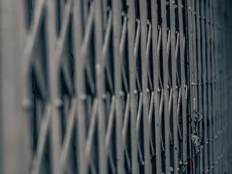 Folding Metal Security Gate in Shallow Focus, Diagonal Perspective Detail Stockfoto's