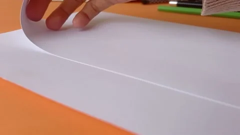 Folding a paper into small pieces Stock Footage 150666418