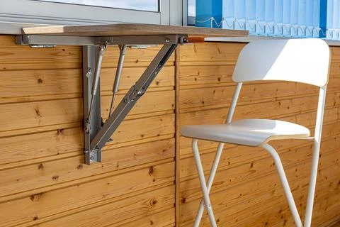 Folding table in the unfolded position on the balcony Stock Photos