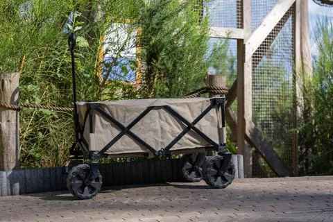 Folding Utility Wagon Parked on Paved Path 库存照片