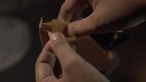 Folding V60 Filter Paper Before Brewing Coffee Close-up of hands folding a .. Stock Footage 306294888
