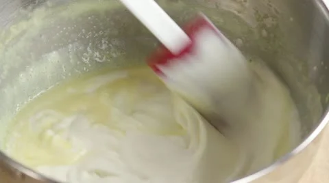 Folding whipped cream into creme Stock Footage 24665776