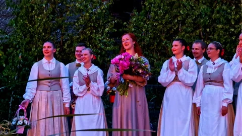 Folk dance troupe celebrating on stage after a performance at summer solstice Stock Footage 339911644
